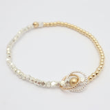 14k gold-filled and fine silver mixed-metal bracelet featuring 2 entwined twisted rings.