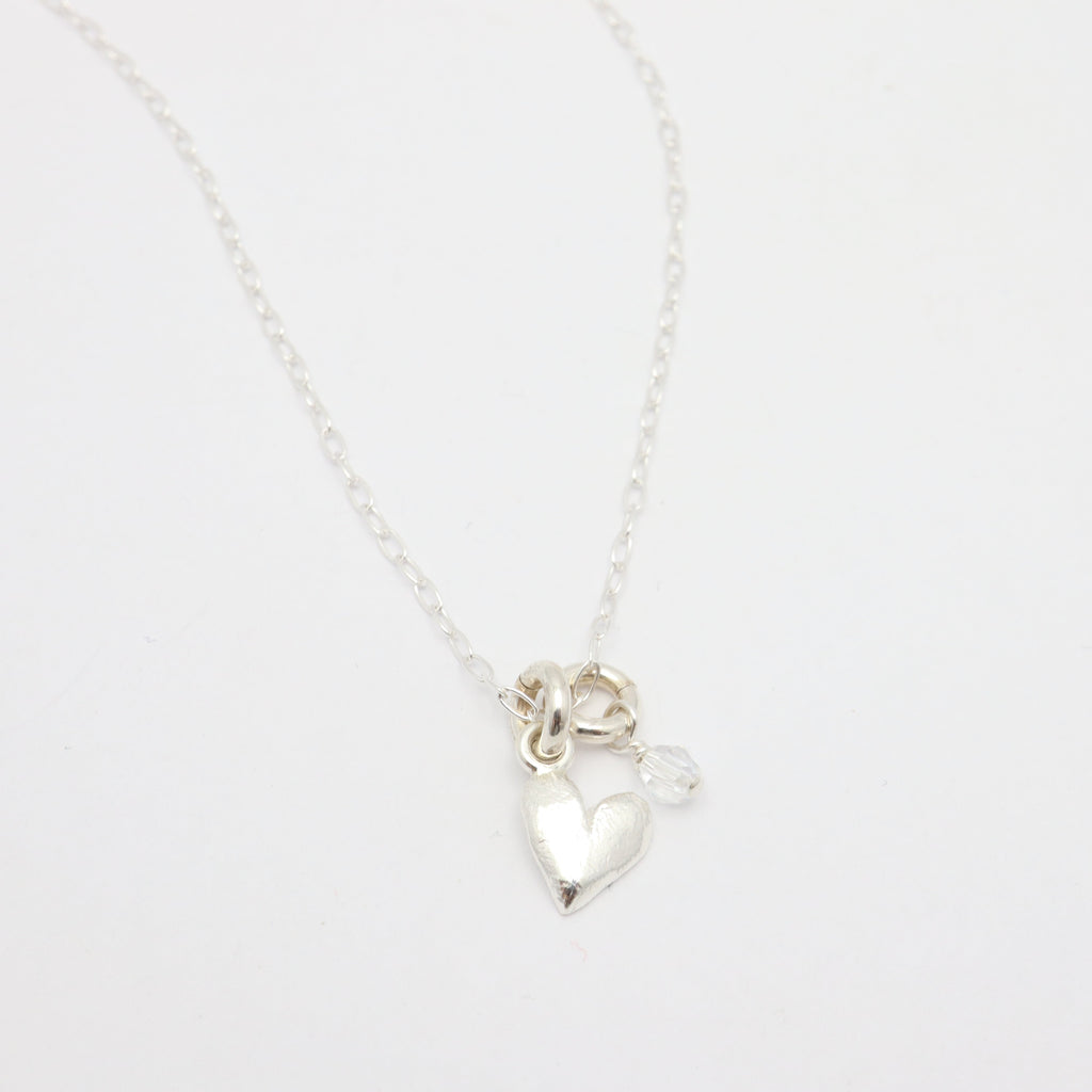 Silver heart pendant on sterling silver chain, featuring a clear Austrian crystal.