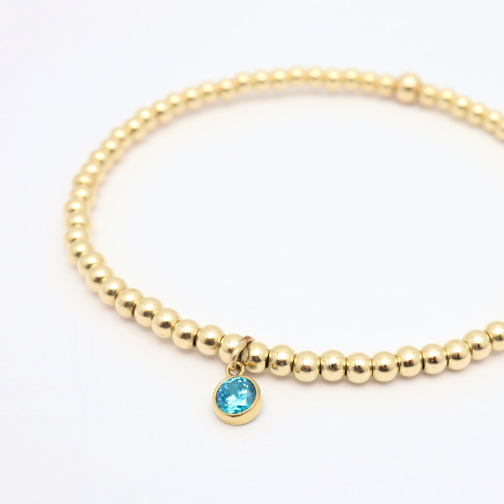 Gold-filled stretch bracelet with sapphire-colored cubic zirconia