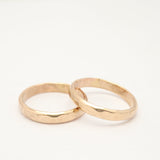 Two gold rings on a white background