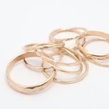Gold rings stacked on a white background