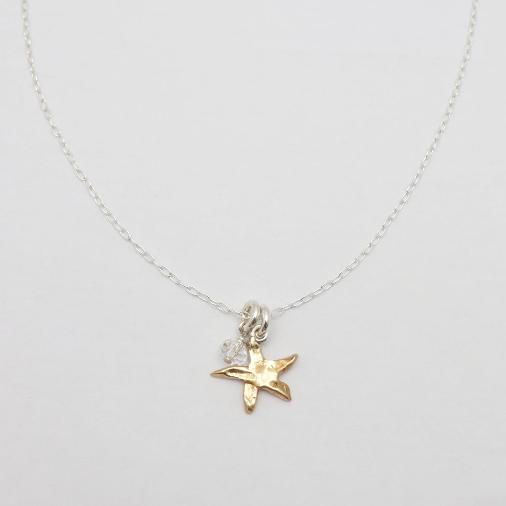 Necklace with a star-shaped pendant on a light gray background