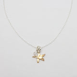 Necklace with a star-shaped pendant on a light gray background